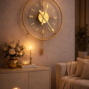 May include: A gold-colored, circular wall clock with a transparent face, featuring Roman numeral hour markers. The clock is mounted on a neutral-toned wall, with a pendulum. The scene includes a vase of flowers, candles, and a sofa.