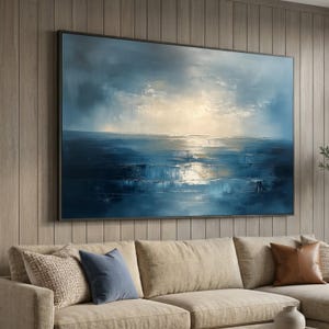 May include: A large rectangular wall art piece featuring an abstract seascape painting with deep blue and navy tones. The composition depicts a turbulent ocean under a cloudy sky with a bright, glowing light source breaking through the centre horizon.