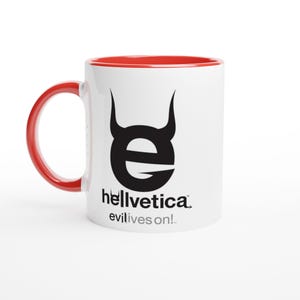 May include: A white ceramic mug with a bright red interior and handle. The front features a black graphic of a lowercase letter e with devil horns, the text hellvetica, and the phrase evil lives on! printed in black and grey lettering.