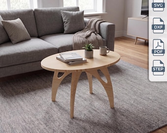 May include: An oval light wood coffee table with three curved legs, featuring a smooth tabletop surface. On the table sits a small potted green plant and a ceramic mug. The image includes digital file icons labeled SVG, DXF, PDF, and STEP.