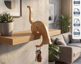 May include: A light brown wooden dinosaur-shaped key holder designed to perch on the edge of a shelf. The figure features a long neck and tail, with a metal ring holding keys suspended from its underside. Includes digital files labeled SVG, DXF, PDF, STEP.