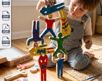 May include: A set of wooden human-shaped figures for stacking, featuring hand-painted designs in red, blue, green, and yellow. The set includes digital files labeled SVG, DXF, PDF, and STEP, with a cardboard box marked STACK THE DUDES.
