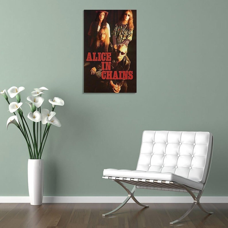 Puede incluir: Un p&oacute;ster de pared rectangular que presenta una fotograf&iacute;a oscura y melanc&oacute;lica de la banda de rock Alice in Chains. Los miembros de la banda aparecen en un retrato grupal con el texto ALICE IN CHAINS en letras rojas may&uacute;sculas.
