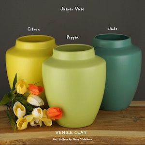 May include: Three ceramic vases in citron, jade, and pippin green colors. The vases are labeled with their color names and the text "VENICE CLAY Art Pottery by Gary Steinborn".