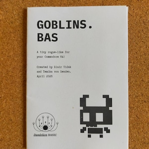 May include: A white booklet titled GOBLINS. BAS, A tiny rogue-like for your Commodore 64! Created by Blair Vidak and Temika von Senden. April 2026. The cover features a black pixelated goblin graphic and a Dandelion BASIC logo in the corner.