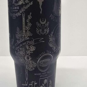May include: Black tumbler with etched designs, including a dragon, sword, and text that reads "Witchling Crescent" and "You do not yield." Features a lid and straw. A unique gift for fans of fantasy and tea.