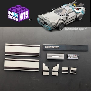 May include: A set of adhesive stickers for a building block car model, featuring a long black strip with the text DeLorean, a small rectangular piece labeled Plutonium Chamber, and various grey and black rectangular decals for vehicle detailing.