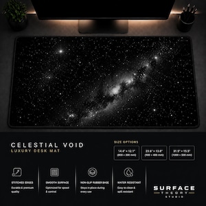 May include: A black and white desk mat with a celestial void design. The mat has stitched edges, a smooth surface, a non-slip rubber base, and is water-resistant. The text "CELESTIAL VOID LUXURY DESK MAT" is displayed. Available in multiple sizes, including 1000 x 500 mm.