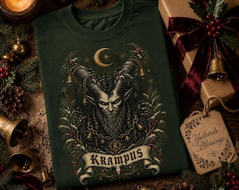 May include: A dark green sweatshirt featuring a detailed graphic of Krampus with large horns, a beard, and chains with bells. The design includes a crescent moon, pine branches, and a banner at the bottom with the text KRAMPUS.