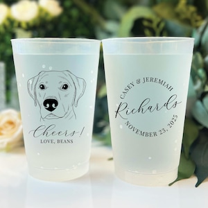 May include: Two frosted plastic cups. One cup features a Labrador Retriever illustration with the text "Cheers! Love, Beans." The other cup has the names "Casey & Jeremiah Richards" and the date "November 23, 2025" in a circular design.