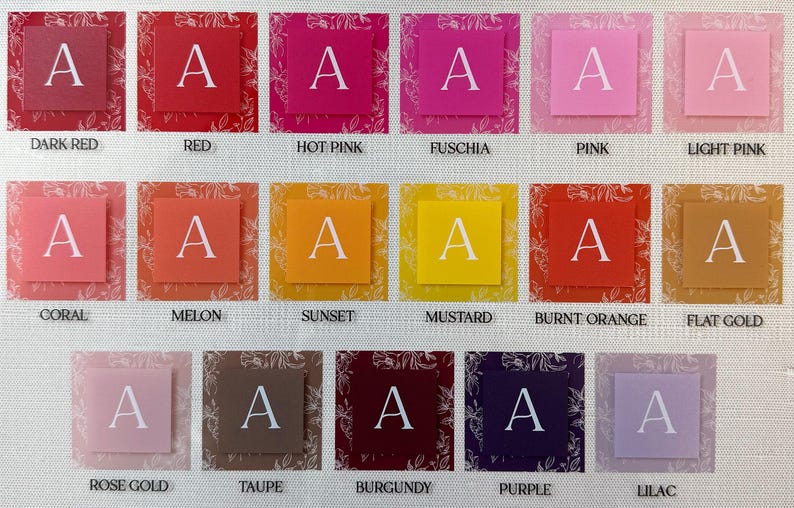 May include: A color chart featuring various shades of red, pink, orange, yellow, and purple. Each color is displayed on a square with the letter "A" in white. The colors are labeled with their names, such as "Dark Red" and "Lilac".