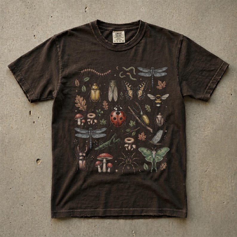 A vintage cottagecore print featuring a detailed collection of insects and woodland foliage. The layout centers on a large ladybug, surrounded by a centipede, dragonflies, a golden beetle, a cicada, a butterfly, a bumblebee, a praying mantis, a stag beetle, a spider, and a green luna moth. Interspersed among the detailed bugs are various red and brown mushrooms, autumn oak leaves, twigs, and tiny mystical stars. The artwork utilizes muted earthy tones for a classic nature aesthetic.