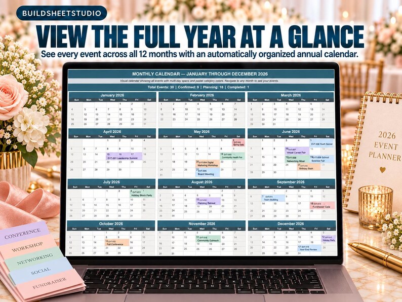 May include: A laptop screen displaying a 2026 annual calendar with twelve monthly grids. The interface features dark blue headers, white date cells, and color-coded event blocks. Text at the top reads: VIEW THE FULL YEAR AT A GLANCE.