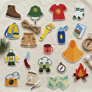 May include: A collection of embroidered patches featuring camping and hiking gear including a brown boot, green hat, red t-shirt, white socks, blue backpack, tan shorts, yellow flashlight, blue water bottle, landscape picture, lantern, knife, binoculars, compass, map, camera, marshmallow, and campfire.