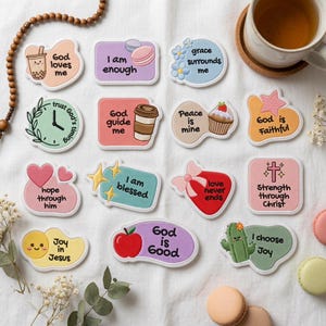 May include: A collection of fourteen embroidered patches featuring various shapes, pastel colors, and inspirational text including phrases like God loves me, I am enough, grace surrounds me, trust God's timing, God guide me, Peace is mine, God is Faithful, hope through him, I am blessed, love never ends, Strength through Christ, Joy in Jesus, God is good, and I choose Joy.