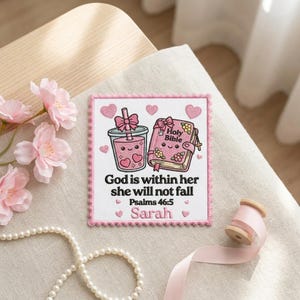 May include: A square embroidered patch with a scalloped pink border featuring a pink drink, a pink Holy Bible, and the text God is within her she will not fall Psalms 46:5 Sarah. The design includes small pink hearts and floral accents.