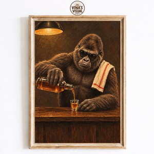 May include: A framed wall art print featuring a gorilla wearing black sunglasses and a white towel with a red stripe over its shoulder. The gorilla is pouring an amber liquid from a glass bottle into a small shot glass on a wooden bar counter.