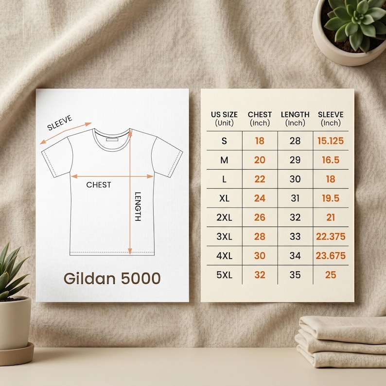 May include: A diagram of a white t-shirt with chest, length, and sleeve measurements. A size chart shows UK sizes S-5XL with chest, length, and sleeve measurements in inches. The brand name "Gildan 5000" is printed at the bottom of the diagram.