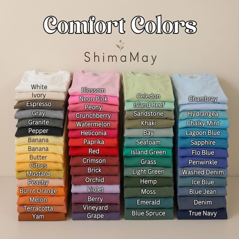 May include: A display of Comfort Colors t-shirts in a range of hues, such as pink, green, and blue. Each stack of shirts is labelled with its colour name. The brand name "Shima May" is also shown.