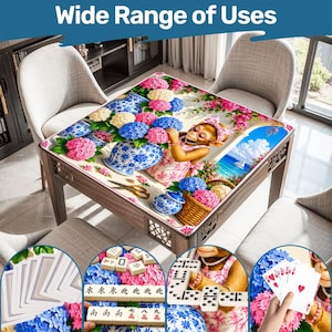 May include: Wooden square table with a decorative floral design and a monkey illustration. The table is surrounded by chairs and features a variety of games, including cards, dominoes, and mahjong. The text "Wide Range of Uses" is at the top.