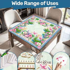 May include: A wooden table with a floral design, featuring pink flamingos, flowers, and greenery. The table has a light blue border and the text "OAK & PALM CO." is visible. The image also shows playing cards, dominoes, and mahjong tiles, suggesting a game table.