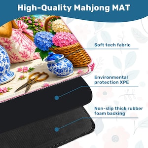 May include: A high-quality Mahjong mat with a floral design featuring blue and pink hydrangeas, a blue and white ceramic jar, and gold scissors. The mat has a soft tech fabric, environmental protection XPE, and a non-slip rubber foam backing.