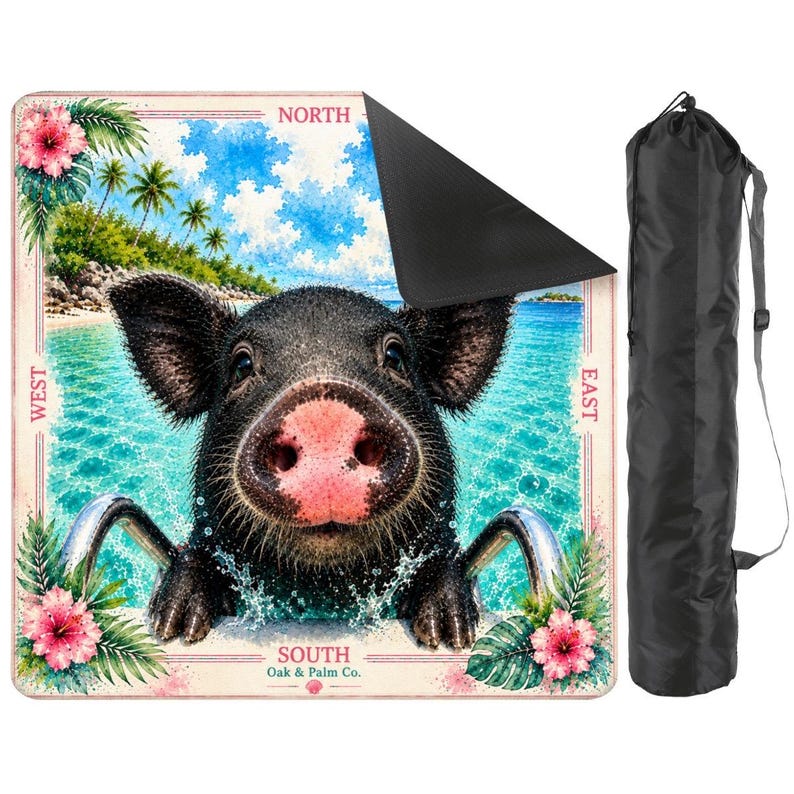 May include: A square outdoor blanket featuring a black pig in a swimming pool with tropical palm trees and hibiscus flowers. The border includes the text NORTH, SOUTH, EAST, WEST, and Oak & Palm Co. A black carrying bag with a strap is included.