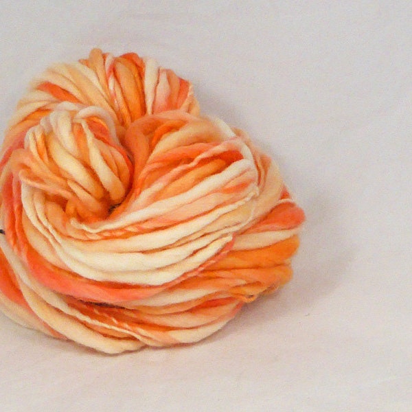 Apricot orange cream  - thick and thin  hand spun, hand dyed yarn. Pure wool slub yarn. Australian 21 micron merino wool.