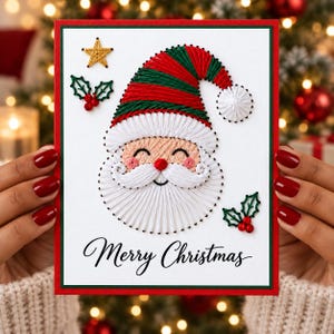 May include: A white greeting card with a string art Santa Claus design featuring a red and green striped hat, a white beard, and a pom-pom. The card includes a gold star, holly sprigs, and the black cursive text Merry Christmas.