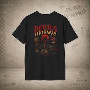 May include: A black short-sleeve t-shirt featuring a graphic print of a highway at night under a red moon. The text reads "DEVIL'S HIGHWAY", "ROUTE 666", "LAST STOP MOTEL", and "NO TURNING BACK". The design includes a car on the road and a pentagram.