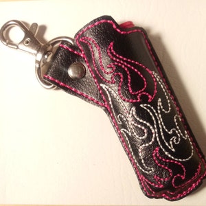 Lighter holder with Pink and White flames embroidered on the front of it. Pink flame lighters