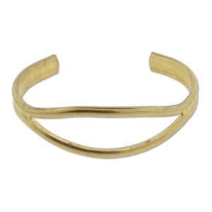May include: A gold-toned metal cuff bracelet with a simple, curved design. The bracelet has a double band, with one band slightly wider than the other.