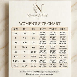 May include: A size chart for clothing featuring the Noore Atelier Studio logo at the top. The chart lists sizes from XS to 4XL with corresponding US and EU sizes, and body measurements for bust, waist, and hips in inches. Text at the bottom reads: Unsure of your size? Message me for assistance! These are body measurements.