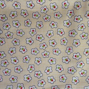 May include: A yellow fabric with a repeating pattern of white flowers with red and green centres. The flowers are outlined in black.