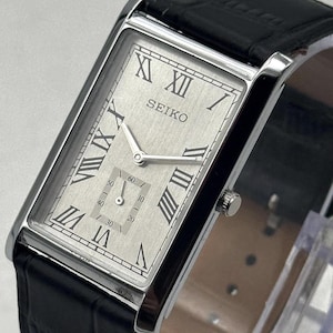 Reloj de pulsera Seiko clásico, raro, vintage, delgado, plateado, rectangular.