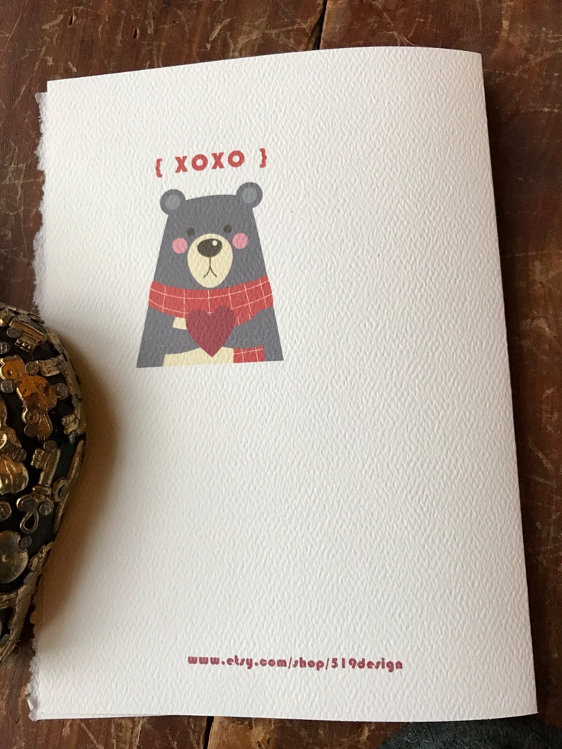 May include: A white card with a gray bear wearing a red and black scarf holding a red heart. The text "{XOXO}" is above the bear and the text "www.etsy.com/shop/S19design" is at the bottom of the card.