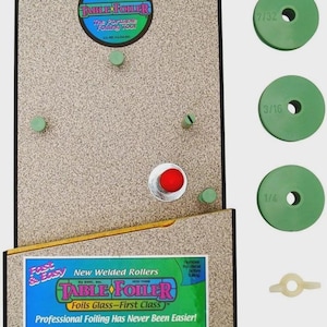 May include: A Table Foiler tool for glass foiling, featuring a beige work surface, green components, and the text "Foils Glass - First Class." Includes green discs labelled 7/32, 3/16, and 1/4, and a white plastic piece.