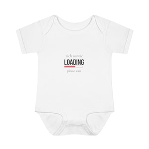 May include: White baby bodysuit with short sleeves. The text "rich auntie LOADING please wait" is printed on the front in black and pink. The word "LOADING" is in bold, with a pink progress bar underneath.