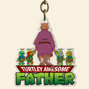 May include: A clear acrylic keychain with a cartoon design of the Teenage Mutant Ninja Turtles and Splinter. The text reads "Turtley Awesome Father" with the names Tom, Anna, Jenny, and Jack. The name David is also included.