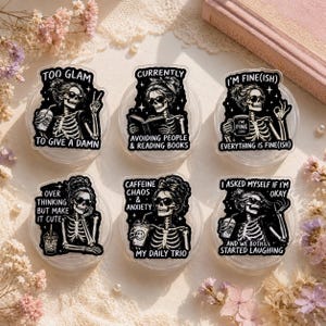 May include: A set of six black and white stickers featuring skeleton figures with sunglasses and messy buns. Each sticker includes text: TOO GLAM TO GIVE A DAMN, CURRENTLY AVOIDING PEOPLE & READING BOOKS, I'M FINE(ISH), OVER THINKING BUT MAKE IT CUTE, CAFFEINE CHAOS & ANXIETY MY DAILY TRIO, and I ASKED MYSELF IF I'M OKAY AND WE BOTH STARTED LAUGHING.