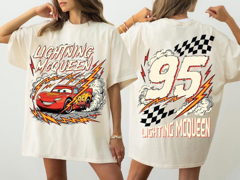 May include: Cream-colored t-shirt featuring Lightning McQueen from the Cars movie. The front graphic shows the red race car with the text "LIGHTNING McQUEEN". The back displays the number "95" with a checkered flag and the text "LIGHTNING McQUEEN".