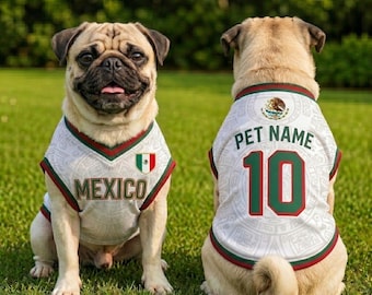 May include: Two fawn-colored pugs wearing white sports jerseys with green and red trim. The front features the text MEXICO and a small Mexican flag. The back displays the text PET NAME, the number 10, and a circular emblem with an eagle design.