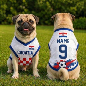 May include: Two pugs wearing white sleeveless jerseys with blue trim. The front features the word CROATIA and the Croatian flag. The back displays the word NAME, the number 9, the Croatian flag, and a graphic of a soccer ball with red and blue accents.