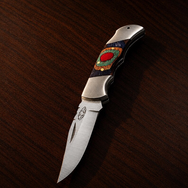 Handmade Damascus-style fixed blade knife with decorative handle .