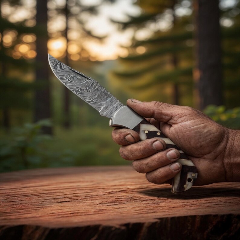 Folding pocket knife with polished steel blade and colorful inlay handle displayed on dark wood.