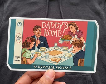 May include: A rectangular sticker featuring a retro-style illustration of a family dinner with the text DADDY'S HOME! A man, woman, and two children sit at a table with bowls and food. The side panel reads A FAMILY GAME and FUN FOR 2-6 PLAYERS.