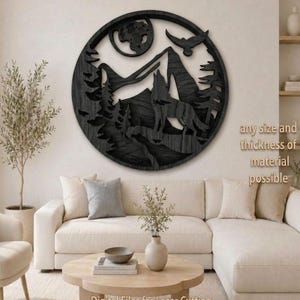 May include: Black wooden wall art depicting a howling wolf in a mountain landscape, with a moon and a flying bird. The art is circular and has the text "LaserNestStudio" at the top. The text "Digital Files for Laser Cutting" is at the bottom.