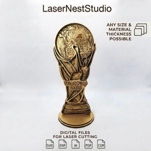 Puede incluir: Un diseño de trofeo de madera en capas con un globo terráqueo y una figura humana, etiquetado WorldCup 2026. El texto incluye LaserNestStudio, ANY SIZE & MATERIAL THICKNESS POSSIBLE y DIGITAL FILES FOR LASER CUTTING con iconos de archivos SVG, DXF, AI, PDF, CDR.