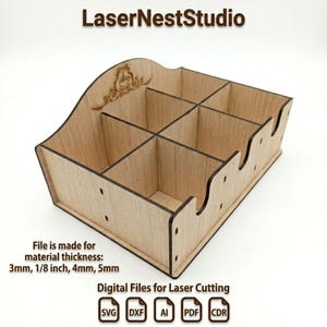 May include: A light-colored wooden organizer with six square compartments and a curved back panel featuring an engraved coffee cup design. The text LaserNestStudio is at the top, with file information for 3mm, 1/8 inch, 4mm, and 5mm material thickness.