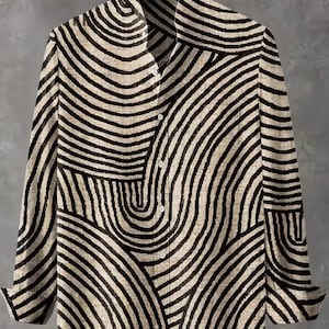 May include: A long-sleeved button-down shirt with a unique black and beige striped pattern. The shirt features a classic collar and buttoned cuffs. The design consists of curved, wave-like lines, creating a bold, eye-catching look. The shirt is made of a soft, lightweight fabric.